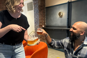 Tour guide handing out beer tastings to guests in hip brewery